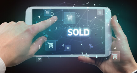 Close-up of a hand holding tablet with shopping inscription