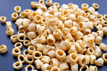 Crispy potato rings on dark background.