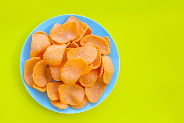 Prawn crackers on green background. Shrimp crispy rice snack