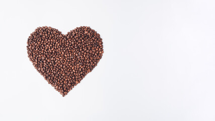 Heart made of coffee beans. Morning routine. Heart shaped coffee beans. Fresh scents. Creative unique drink concept. Trendy minimal background. Flat lay. Cappuccino fun.