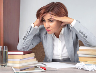 Business woman tired in the office and worried in emotions. Stress and headache