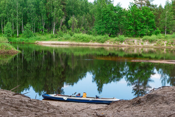 Outdoor activities forest river reflection of sky and kayak