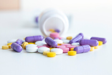 Influenza treatment. Many colorful pills and capsules on a white background