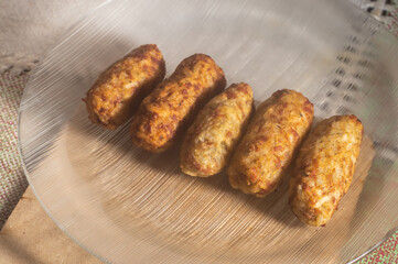 Rice patties or fritters made of cooked rice, carrot, onion, garlic, celery stalks,Brazilian rice cakes,copy space and natural anbiente.