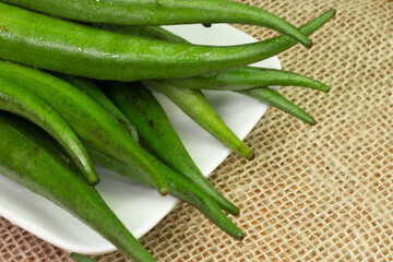 Okra piece on a white bowl on a table