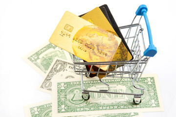 Dollars and credit cards in a shopping cart. Business investments and purchases. Sales market and...