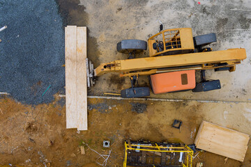 Construction site in the work forklift truck with planks, delivery of loading a wooden plywood