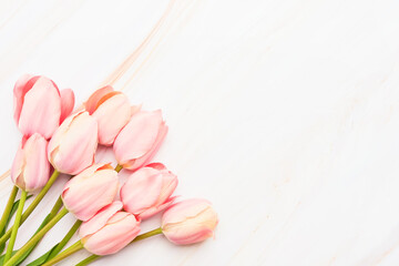 Pink tulips bouquet on marble background. Mothers Day, Valentines Day, birthday celebration concept