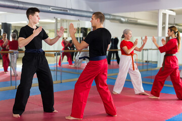 Two men training in sparring at karate training in the gym