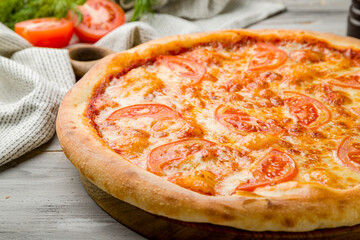 Italian pizza Margherita on grey wooden table macro close up