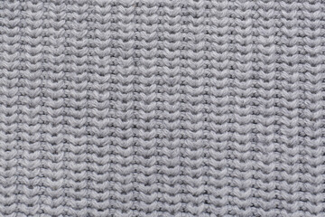 Grey knitted fabric as background, top view