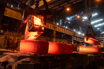 The red-hot metal casting is piled on the platform