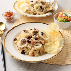 Nasi Kebuli, Arabian Spiced Rice with Lamb Meat and Raisin. Spiced with Cinnamon, Clove, Star Anise. Servd on Cream Ceramic PLate with Golden Rim. usually Served during Eid al Fitr (lebaran)