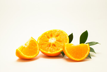 A sliced orange fruit. Fresh-looking yellow fruit on a white background. Fruits with vitamins and good health focus on specific points. Advertising concept and healthy food, space for text