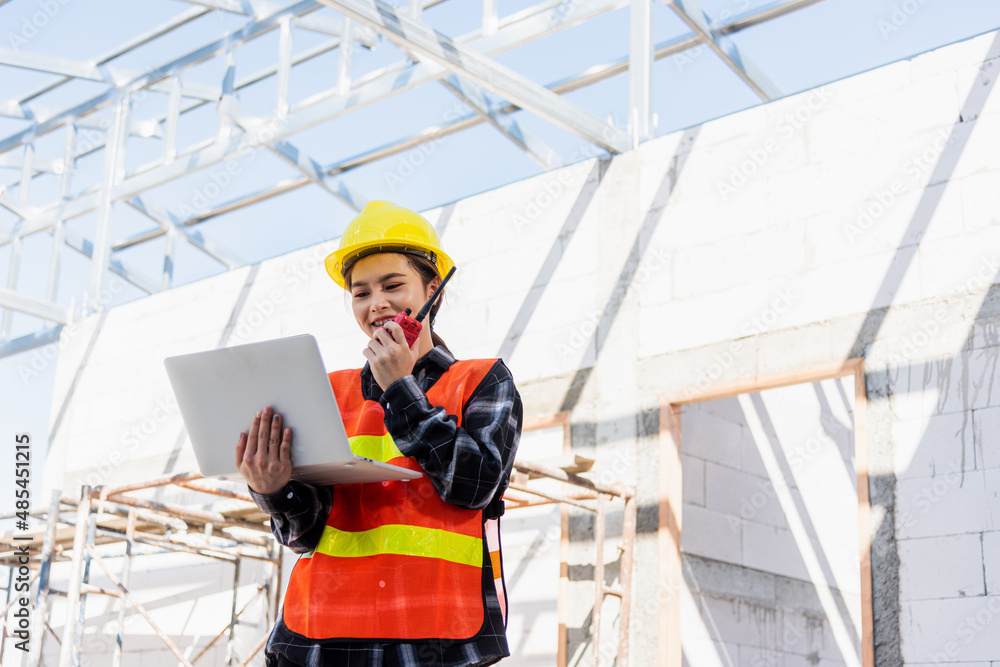 Poster asian engineer architect worker woman working at build construction site use laptop and talking with