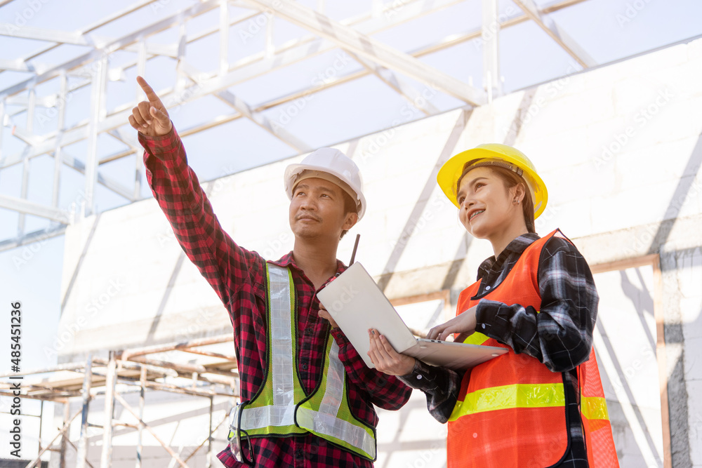 Poster asian engineer foreman worker man and woman working at building construction site use laptop and tal