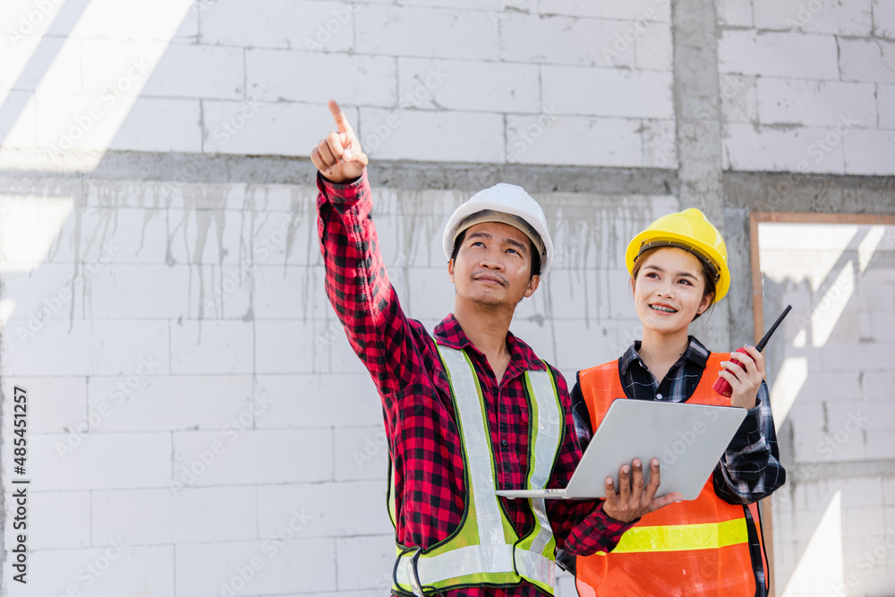Poster asian engineer foreman worker man and woman working at building construction site use laptop and tal