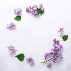 Flowers composition. Circle made of lilac flowers and green leaves on stone background. Mothers day, womens day concept. Copy space for your congratulations