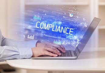 Closeup of businessman hands working on laptop