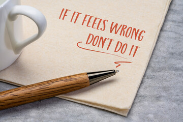 if it feels wrong do not do it advice, handwriting on a napkin with a cup of coffee, instinct and...