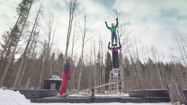 SLOW MOTION - circus performers balancing on shoulders, teeterboarding