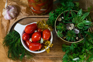 Canned vegetables. Homemade pickled vegetables from a glass jar. Pickled tomatoes, dill, garlic, parsley. Country food.