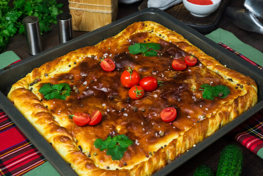 A Square Meat Pie On An Iron Tray. Greased With Butter, Sprinkled With Pepper And Salt. Country Style. Cooked At Home.