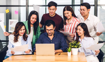 Group of asian business meeting and discussing strategy startup project analysis finance process.Success business people work plan and brainstorm marketing idea with laptop in office.Teamwork