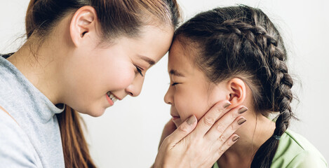 Fototapeta premium Portrait of enjoy happy love asian family mother and little asian girls child smiling and having fun touching face with cute kid daughter moments good time
