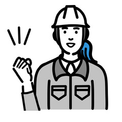 笑顔でガッツポーズをしているヘルメットをかぶった現場作業員の女性
