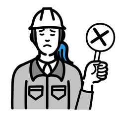 バツの札を持って残念そうなヘルメットをかぶった現場作業員の女性
