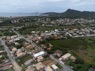 Amazing seaside town amidst nature and mountains top view, drone - Armação de Búzios, Rio de Janeiro, Brazil
