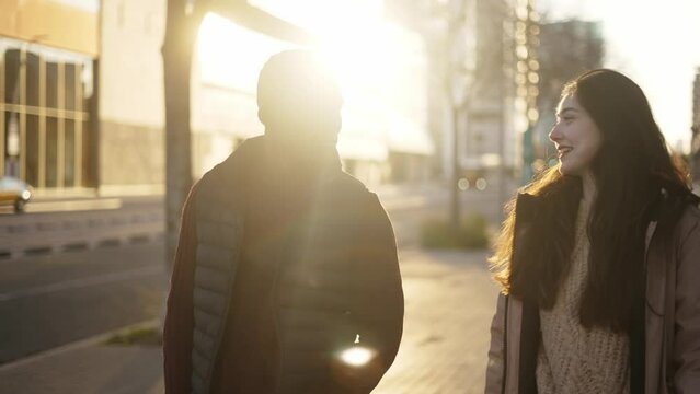 Content multiracial friends walking along street