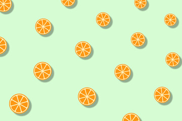 Colorful fruit pattern of orange slices on light green background with shadows. Seamless pattern with orange. Top view