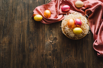 Multicolored Easter eggs on a wooden background. Easter background. Copy space. Easter eggs flat lay on rustic table. Easter concepts