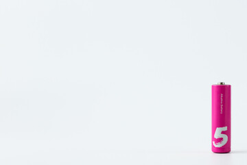 Pink alkaline battery on a light background