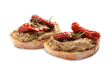 Slices of bread with delicious pate, sun dried tomatoes and rosemary on white background