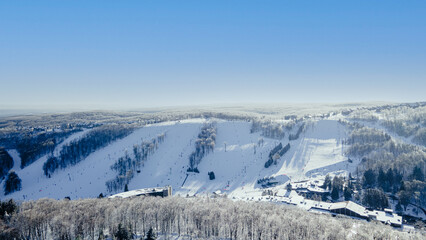 Fototapeta na wymiar winter ski slope landscape in the mountains aerial