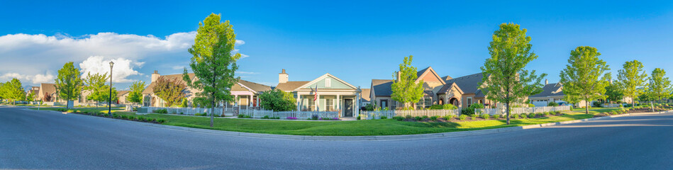 Fototapeta na wymiar Panoramic view of houses with picket fence and different structures at Daybreak in Utah