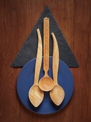 handmade wooden spoons on a wooden background