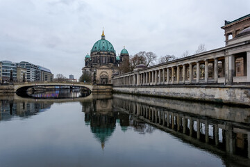 Fototapeta na wymiar View of the Berliner Dom (Berlin Cathedral), a monumental German Evangelical church and dynastic tomb (House of Hohenzollern) on the Museum Island in central Berlin from the bank of the River Spree
