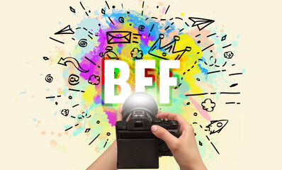Close-up of a hand holding digital camera with abstract drawing