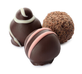 Many different delicious chocolate truffles on white background