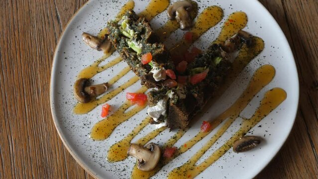 Delicious vegan protein steak served with mushrooms in healthy dietary restaurant, alternative meat dishes