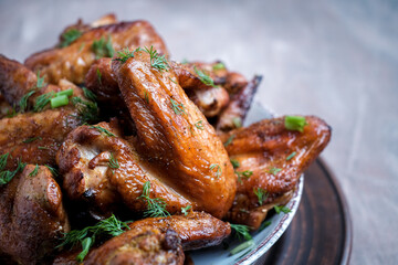 Barbecue chicken wings on wooden table. Top view.