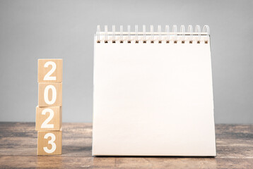 2023 mockup notepad. 2023 cubes wooden table background. New Year. plans for 2023, space for your...