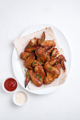 Barbecue chicken wings on white background. Top view.