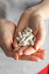 A handful of pills in female hands.