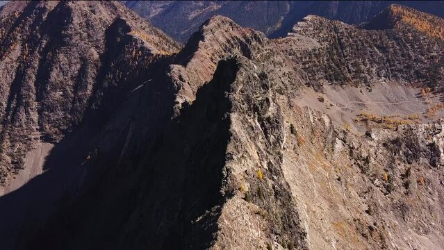 Flying above the ridgeline high in the alpine of Purcell mountains, autumn