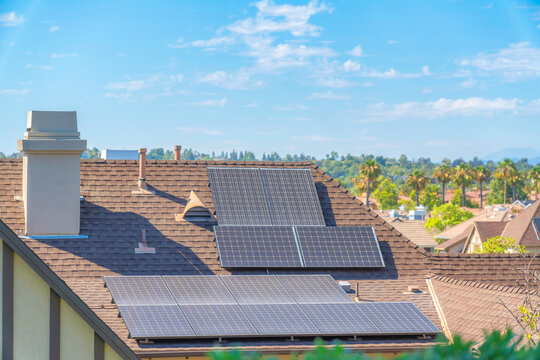 Solar panels on top of the asphalt composite shingles roof of a house at Ladera Ranch, California